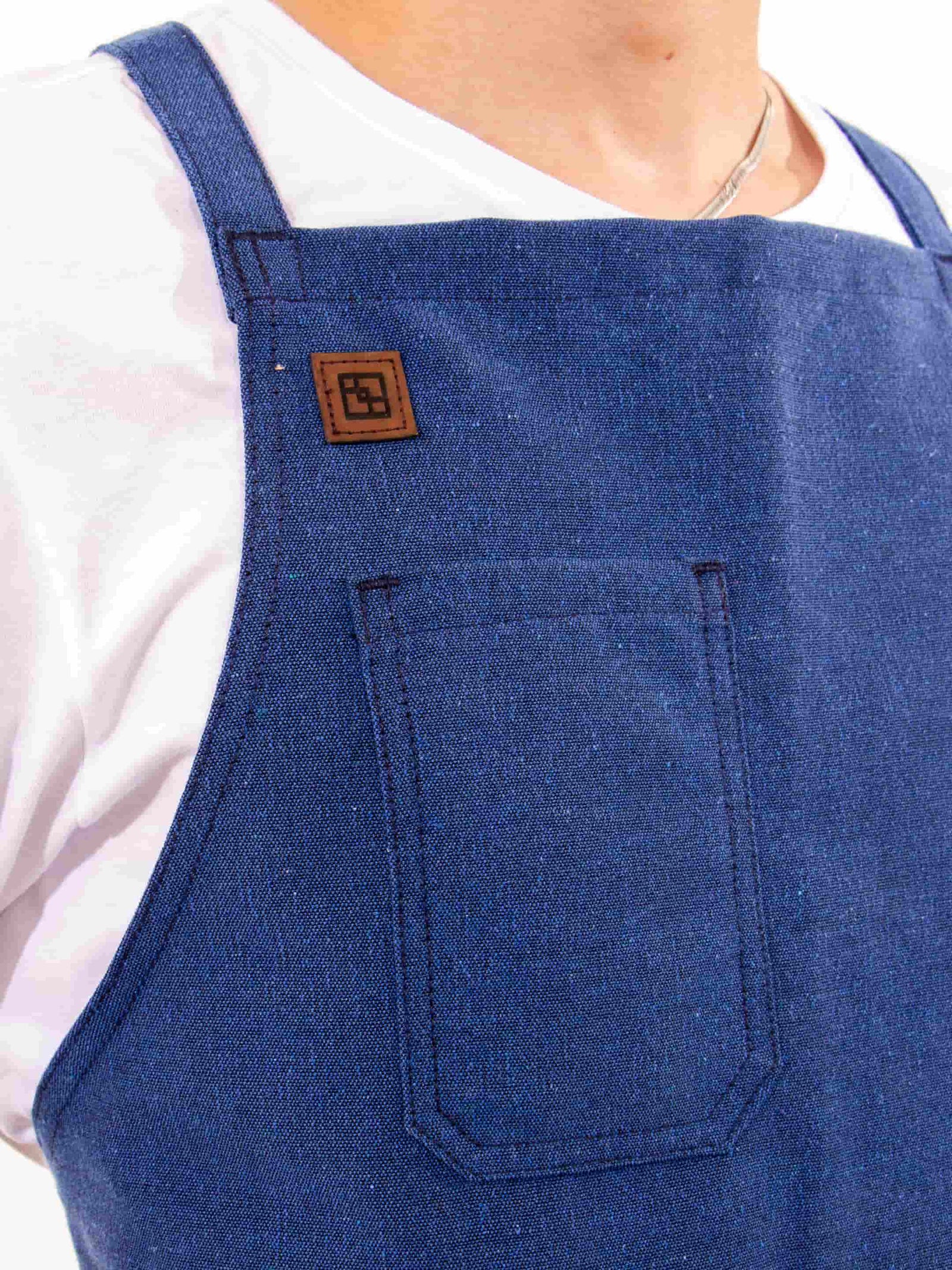 Close-up of the Blueberry Blue apron chest pocket and logo