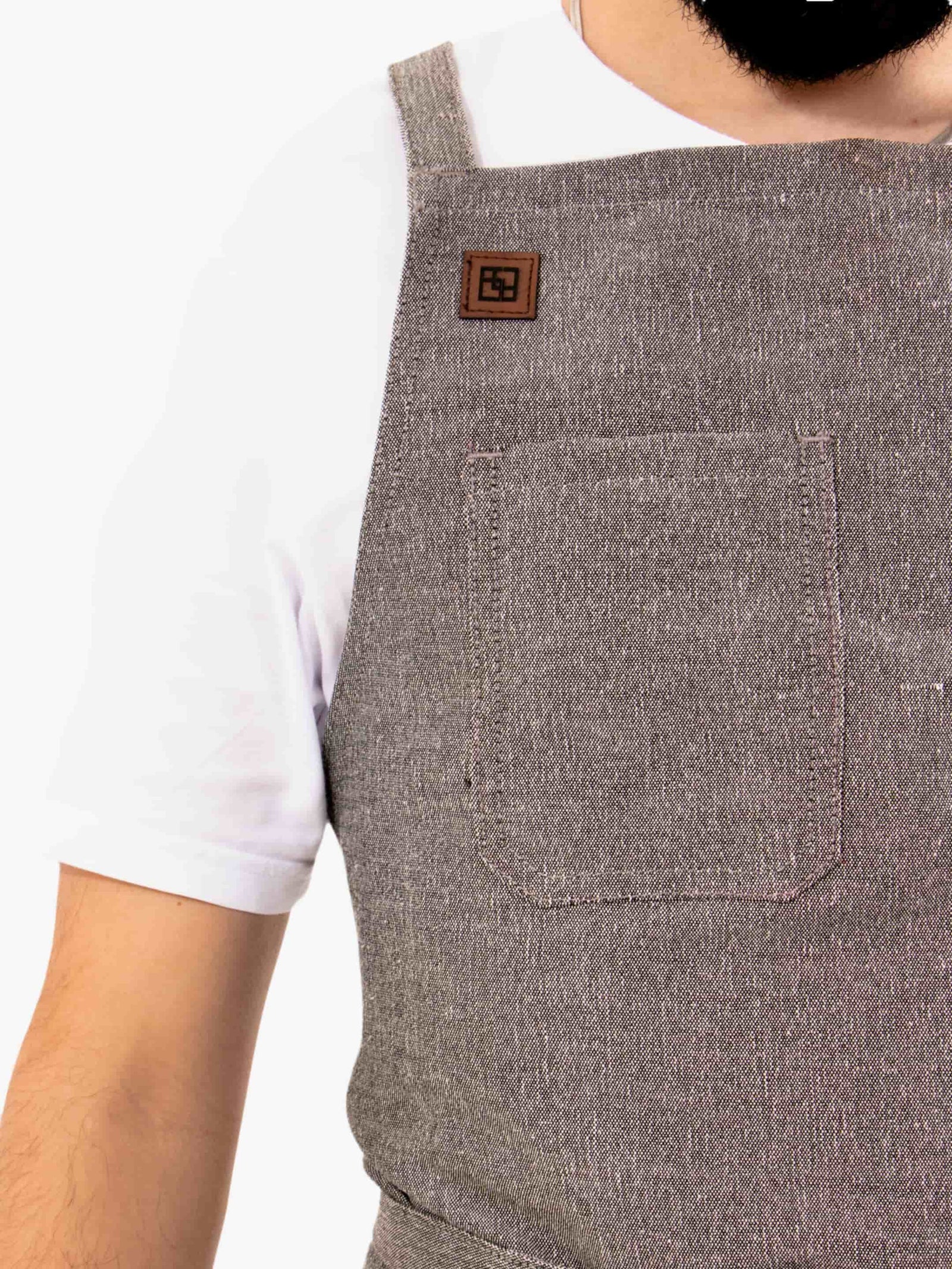 Close-up of the Dragonfruit Grey apron chest pocket and logo